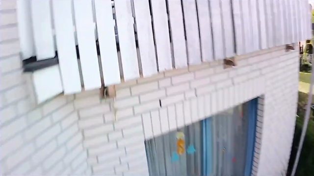 Action cam frame at 0:09: the balcony railing of the house next door, right before the impact